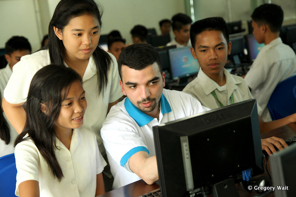 Des étudiants de PNP groupés près d'un prof de PNP qui leur explique quelque chose sur leur ordinateur.