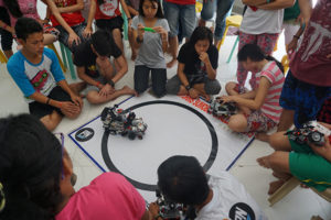 Students taking part in a Lego Mindstorms Sumo Battle